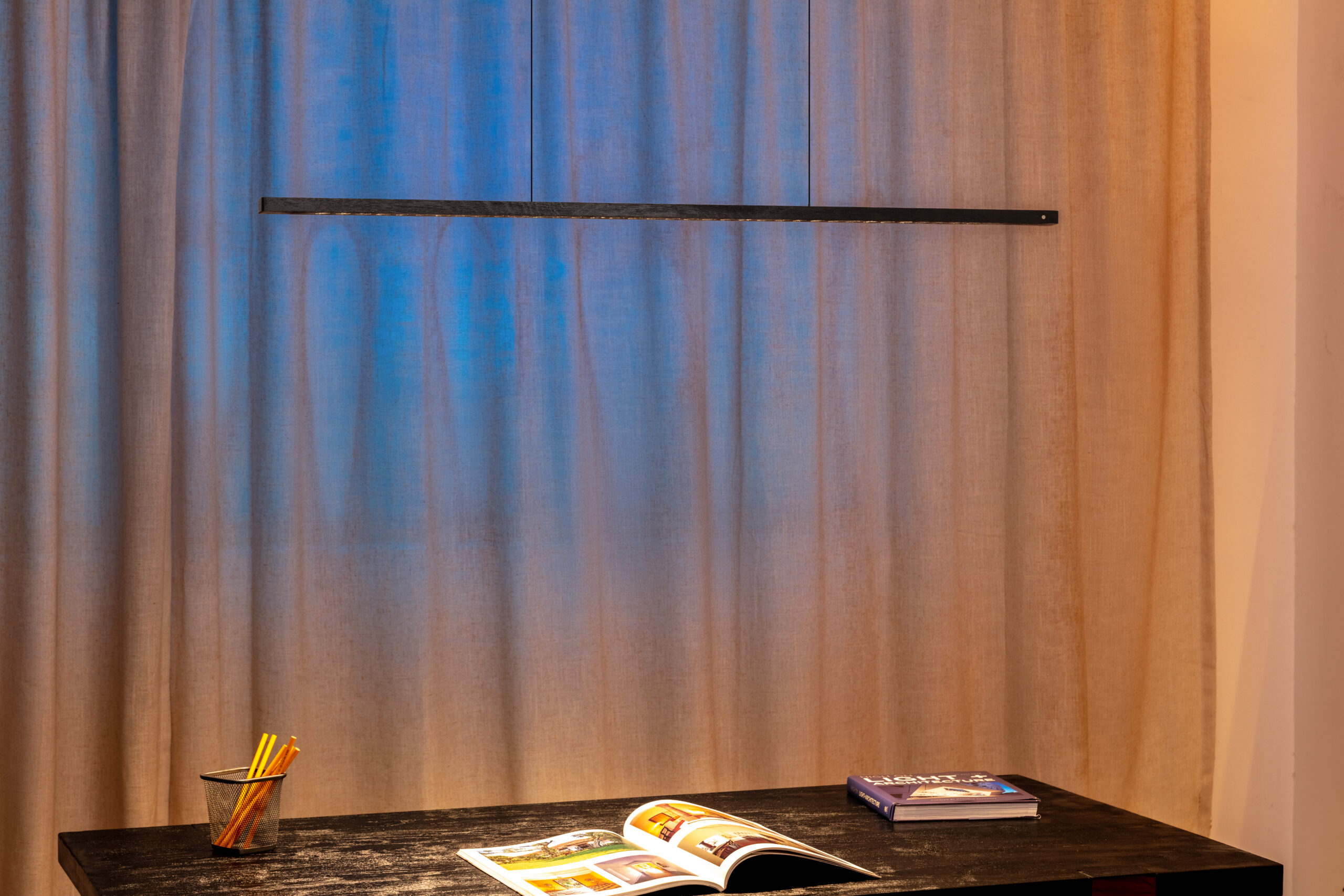 Linear solid wood pendant in a calm interior