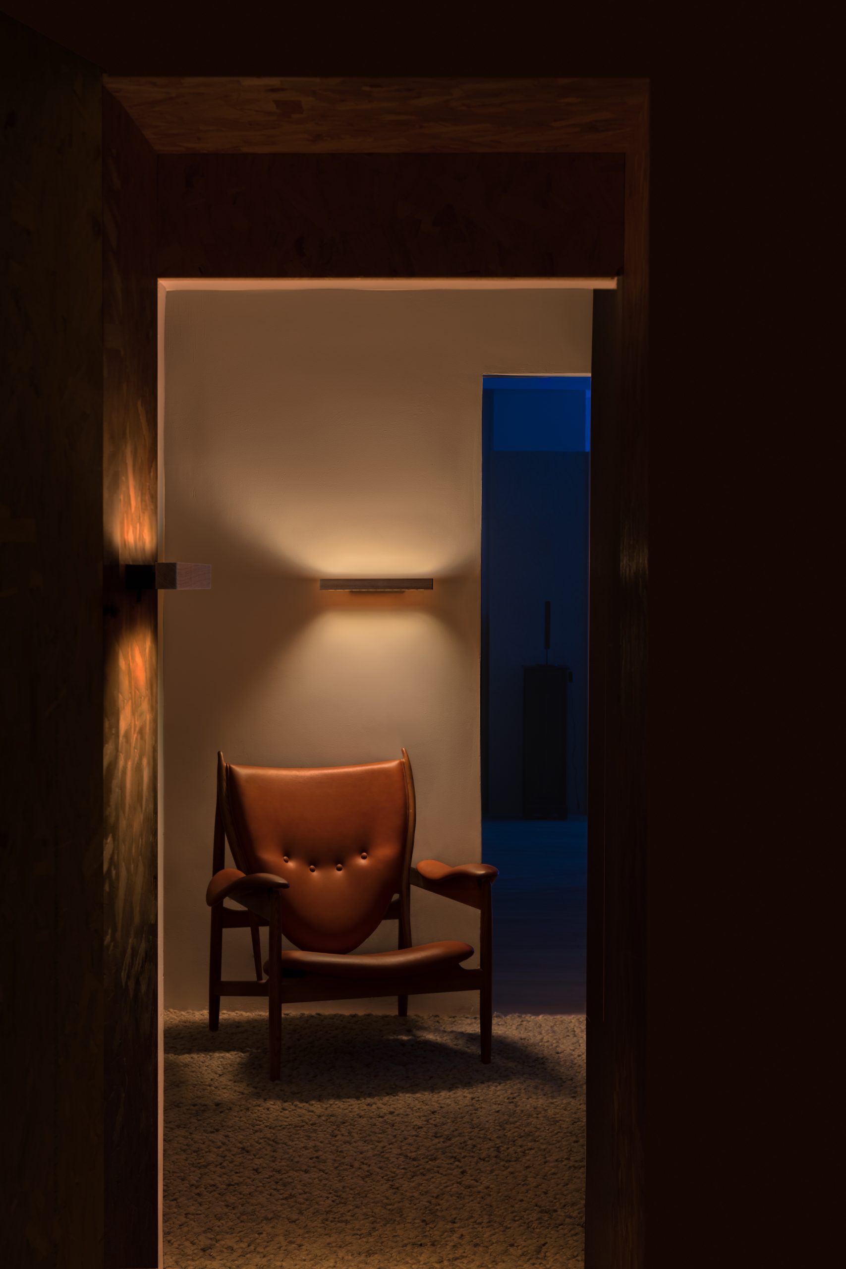 Lumatree Wall photographed above an armchair with uplight and downlight
